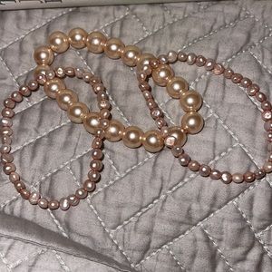 Pink/ Rose assortment of pearl bracelets.